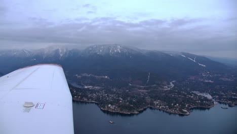 Pilot-View-of-Airplane's-Wing-In-Flight-and-Mountain-Coastal-Landscape