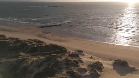 Sunset-aerial-view-of-Ofir-Beach-with-sand-dunes-and-ocean-in-Esposende,-Portugal