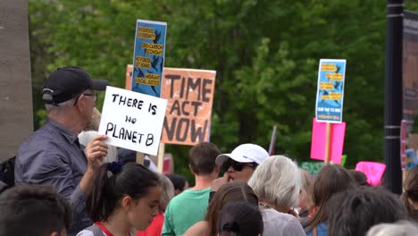 Man-holding-sign-during-climate-change-protest