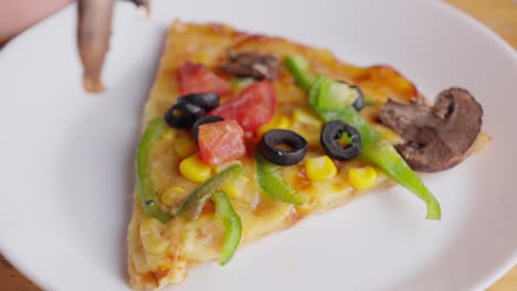 Closeup-shot-Asian-hand-grabs-slice-of-mushroom-from-vegetarian-pizza-food-dish