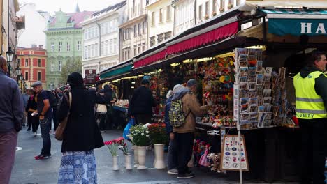 Various-people-walking-over-a-market-square-in-the-old-center-of-Prague-buying-from-a-market-stand