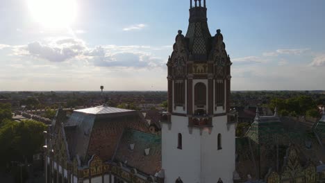 Aerial-view-of-the-ornate-top-of-city-hall-tower-in-City-of-Felegyhaza,-Hungary