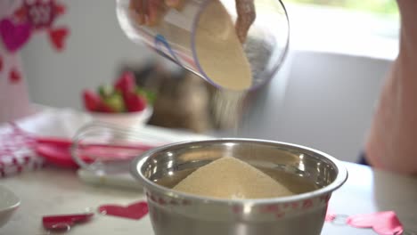 Nice-angle-of-brown-sugar-being-poured-into-bowl-of-flour-making-a-special-valentine's-day-cake-vegan-chocolate-cake-eggless-plant-based-dairy-free