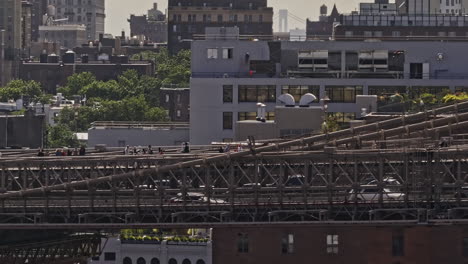 NYC-New-York-Aerial-v430-zoomed-flyover-East-river-capturing-pedestrians-crossing-and-vehicle-traffics-on-Brooklyn-bridge-against-Brooklyn-Heights---Shot-with-Mavic-3-Pro-Cine---September-2023