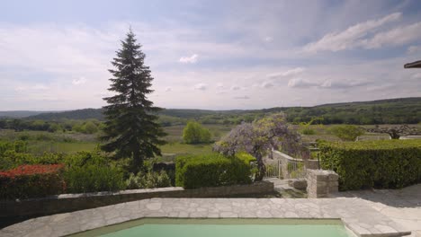Slow-rising-shot-revealing-the-French-countryside-from-a-small-private-pool