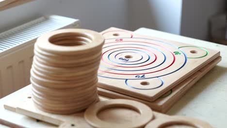 Stack-of-wooden-rings,-pieces-for-game,-puzzles,-ready-for-assembly-in-game-factory