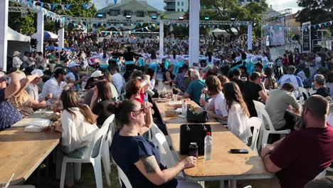 Large-crowd-enjoying-greek-food-while-watching-a-dance-show-at-Paniyiri-greek-festival-in-Brisbane,-Australia