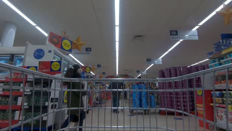 POV-From-Inside-Trolly-Going-Down-Central-Aisle-In-Tescos-During-Christmas