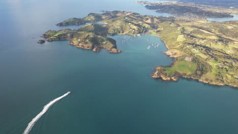 Vista-Aérea-Del-Ferry-Que-Cruza-La-Bahía-De-Matiatia-En-Auckland,-Nueva-Zelanda---Disparo-De-Un-Dron