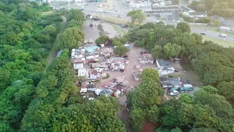 aerial-view-of-a-home-made-shacks-squatter-camp-next-to-a-canal-surrounded-by-bushes-on-the-bluff-in-Durban-south-Africa