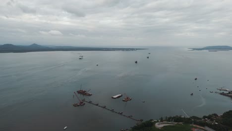 Cargo-ships-and-small-boats-sailing-towards-the-port-of-São-Francisco-do-Sul-in-Babitonga-Bay,-Santa-Catarina,-Brazil