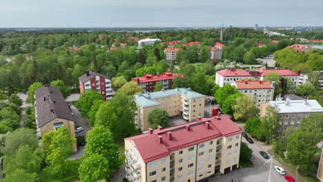 Drone-flying-over-colorful-condos,-summer-day-in-the-Drumso-district-of-Helsinki