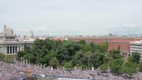 Tilting-down-view-shot-of-Cibeles-Square-as-thousands-of-Real-Madrid-fans-gathered-to-celebrate-the-36th-Spanish-soccer-league-title,-La-Liga-championship-in-Madrid,-Spain