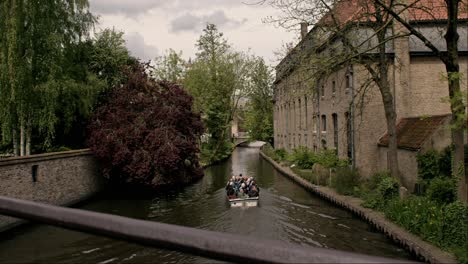 Tourists-On-Boat-Canal-Tour-In-Bruges,-Belgium