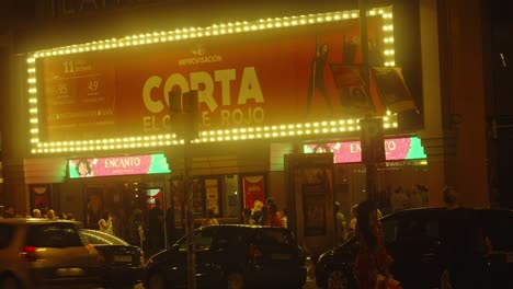 Concurrido-Teatro-De-La-Ciudad-De-Barcelona-Durante-La-Noche,-Calle-Iluminada-Llena-De-Gente-Y-Coches-Circulando-Por-La-Carretera.-