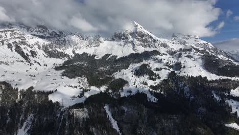 Cinematic-view-of-Glarus-snowy-mountains-with-clouds-in-Switzerland