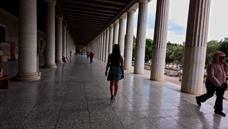 Young-woman-walking-in-Stoa-of-Attalos-Museum-of-the-Ancient-Agora-Athens-Greece