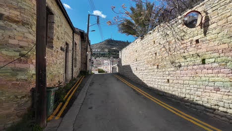 Narrow-uphill-street-in-Lefkara-lined-with-stone-walls-and-houses