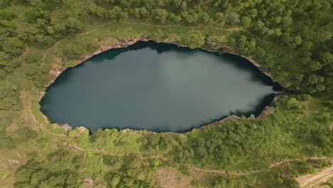 Aerial-drone-top-down-view-of-Tritriva-volcanic-lake-in-crater-located-in-countryside-near-Antsirabe-in-Madagascar