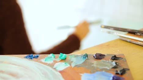 Una-Artista-Pintando-Con-Su-Paleta-En-Primer-Plano