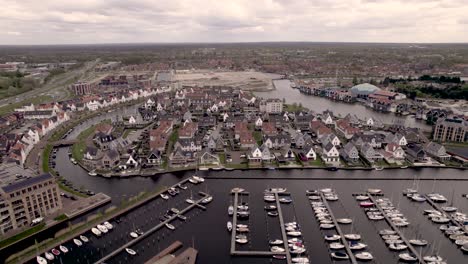 Aerial-of-De-Knar-recreational-port-at-the-Veluwemeer-with-pleasure-boats-and-lighthouse-with-dolfinarium-in-the-background