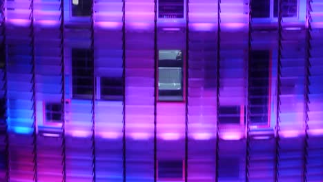 Futuristic-lift-of-a-multicolored-skyscraper-glowing-at-night