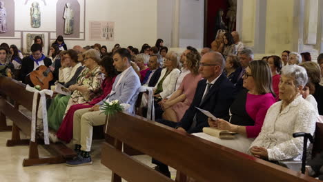 People-Attending-the-First-Communion-Ceremony-in-a-Catholic-Church-in-Zaragoza,-Spain---Pan-Right-Shot