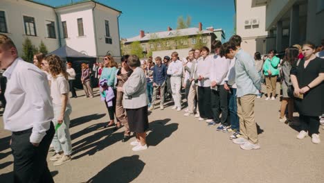 Well-dressed-boys-during-high-school-graduation-ceremony-in-courtyard