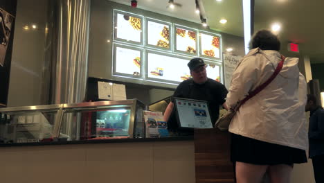 People-buying-New-York-fries-at-food-court-area-inside-Burnaby-shopping-mall-with-4k-resolution