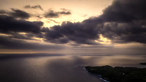 Clouds-moving-in-sky-at-sunset-over-sea,-Nusa-Penida,-Bali-in-Indonesia