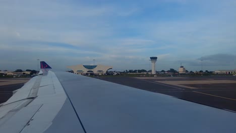 Aircraft-window-view-of-SN-Brussels-airplane-taxiing-at-Banjul-international-airport,-Gambia