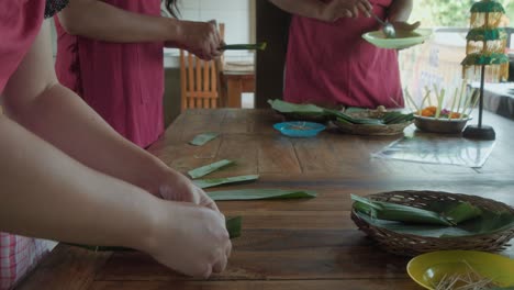 three-women-prepare-the-traditional-Indonesian-dish-Sate-lilit-or-satay