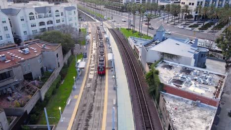 San-Diego-Trolley-along-Harbor-Drive-area,-drone-fly-over-view
