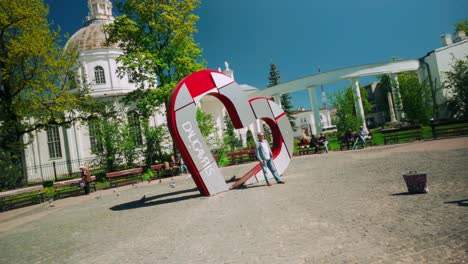 Daugavpils-tourist-promotional-heart-landmark-with-man-posing-for-wife
