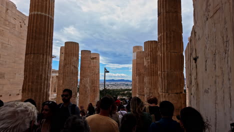 Crowded-People-Walking-Through-The-Pillars-Of-Monument-Agrippa-In-The-Acropolis-of-Athens,-Greece