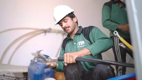 Static-shot-of-Pakistani-electricians-working-on-damages-wires-in-a-textile-industry-of-Pakistan