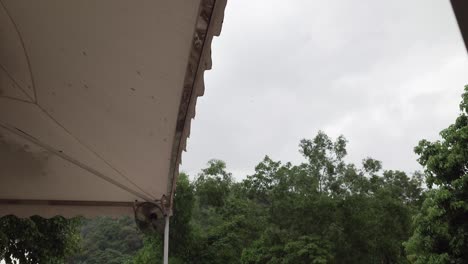 Edge-of-tent-on-rainy-day-in-rural-Hong-Kong,-static-view-from-below