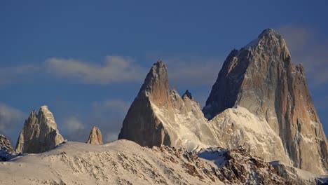 Mount-Fitz-Roy-bathed-in-golden-light-with-drifting-clouds-in-Patagonia,-Argentina