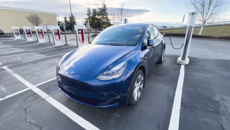 Electric-car-charging-at-a-Supercharger-facility