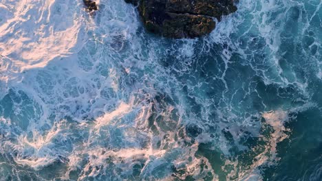 La-Jolla-Cove-Drone-Top-Down-Flyover-Bottom-of-Frame-to-Top-Waves-Crashing-On-Rocks-During-Golden-Sunrise-light