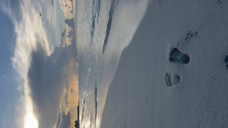 Feet-marked-in-the-white-sand-on-the-seashore