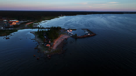 Aerial-view-away-from-the-Keskuskari-island,-summer-sunset-in-Kalajoki,-Finland