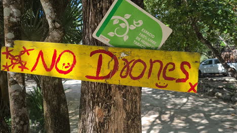 No-Drone-Sign-Board-at-Entrance-to-Cenote-Area-in-Landscape-of-Mexico,-Close-Up