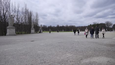 Warmly-dressed-visitors-strolling-through-Schonbrunn-Palace-Park