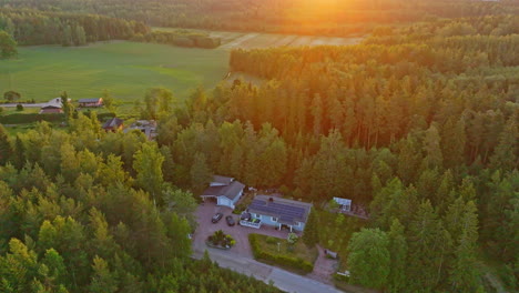 Aerial-overview-a-sun-powered-house,-vivid-summer-morning-with-solar-flares