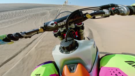 Riders-racing-at-speed-across-sandy-terrain