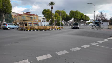 Roundabout-in-Nicosia,-Cyprus,-featuring-a-central-fountain-and-colorful-flower-arrangements
