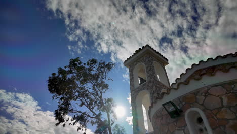 Silhouette-of-bell-tower-and-tree-with-cloudy-sky-backdrop---Lefkara
