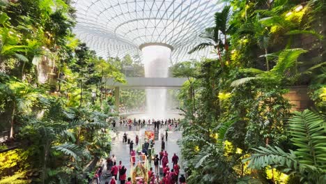 Tourists-at-Famous-Waterfall-in-Terminal-of-Jewel-Changi-Airport-in-Singapore