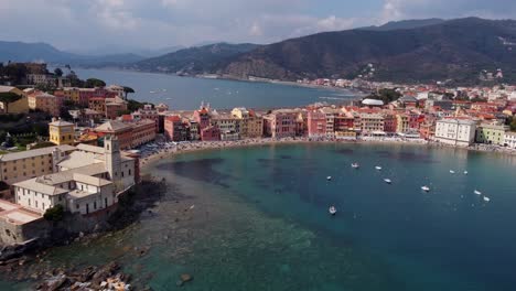 Sestri-levante,-italy-showcasing-colorful-buildings-and-clear-turquoise-water,-captured-during-daylight,-aerial-view